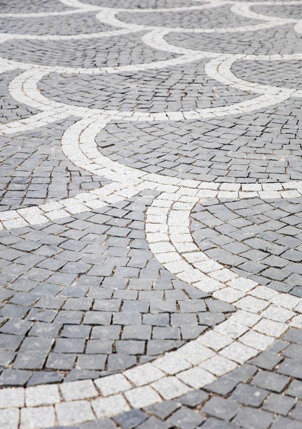 Wavy pattern on cobblestone pavement.