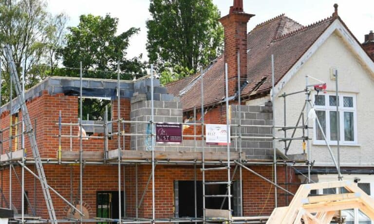 House extension construction with scaffolding in the UK.