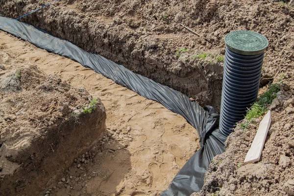 Drainage installation in construction trench.