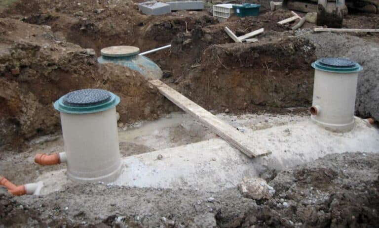 Construction site showing underground piping installation.