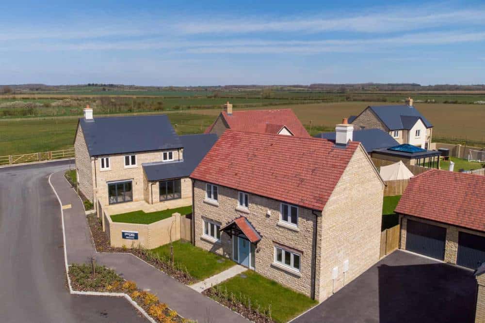 New suburban homes in rural setting, clear blue sky.