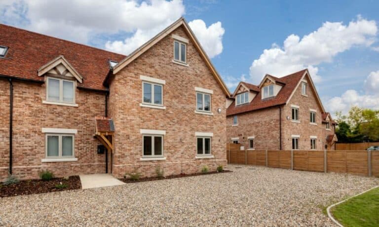 New brick houses with gravel driveway in UK.