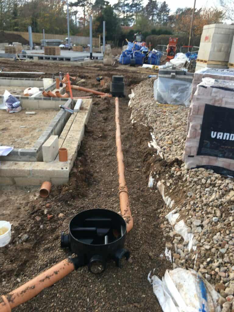 Construction site with drainage installation underway