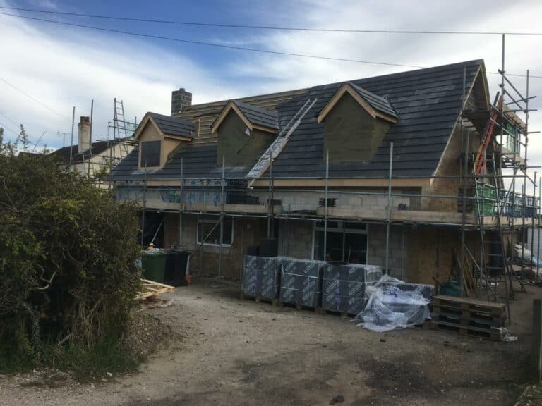 House under construction with scaffolding in the UK.