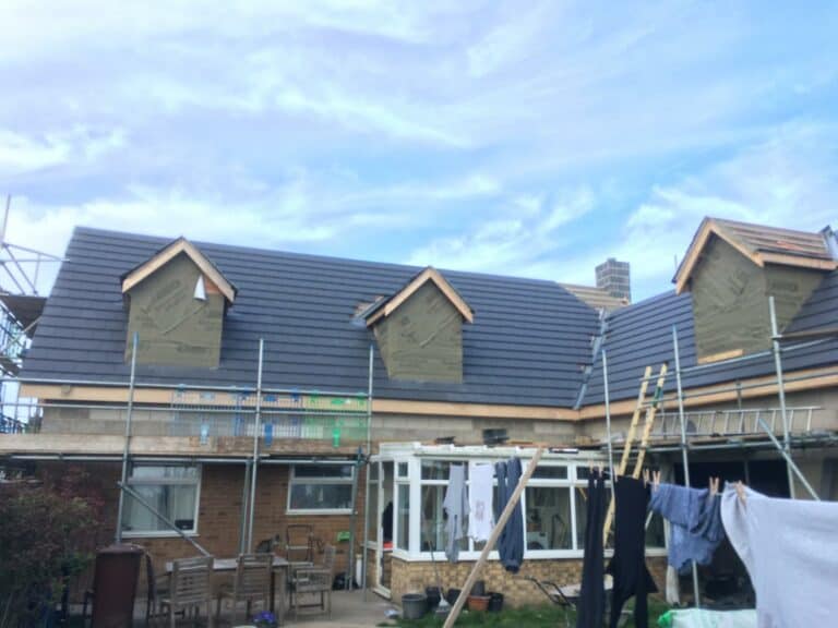 House extension under construction with scaffolding.