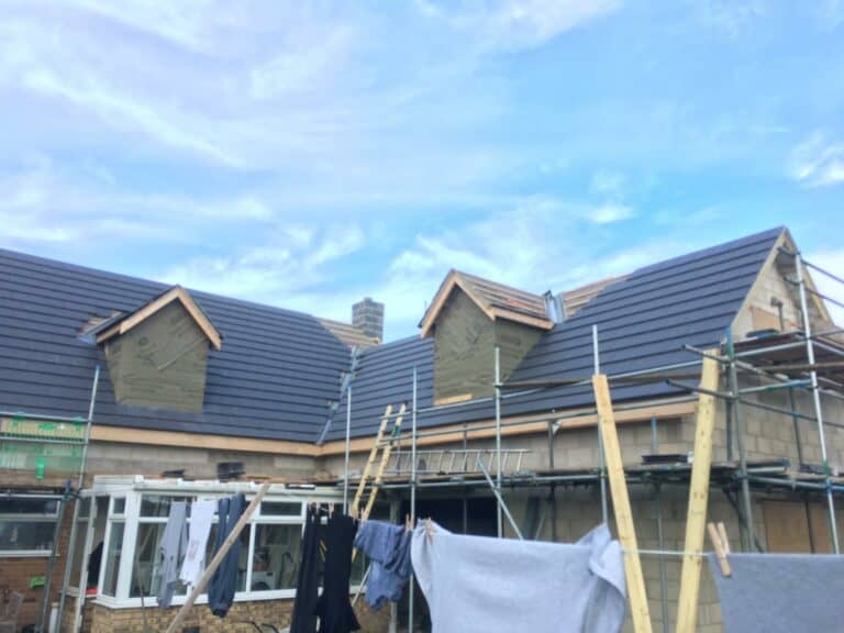 House under construction with scaffolding in UK.