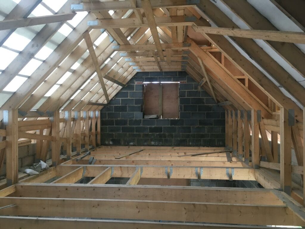 Timber roof framing and floor joists during structural work in King’s Lynn.