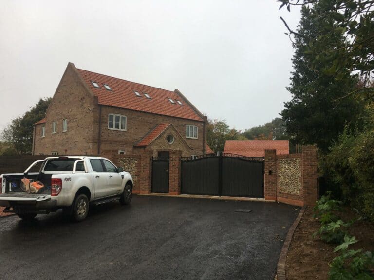 Brick house with driveway and pickup truck in UK.