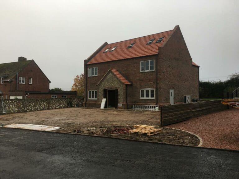 Traditional brick house under construction in rural area.