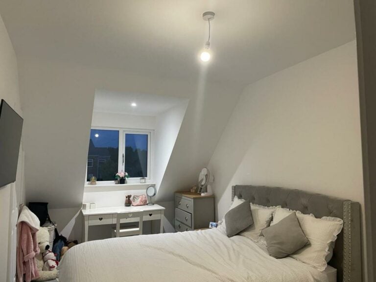 Modern bedroom with evening moon through window.