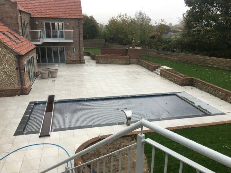 Backyard with covered pool and patio area.