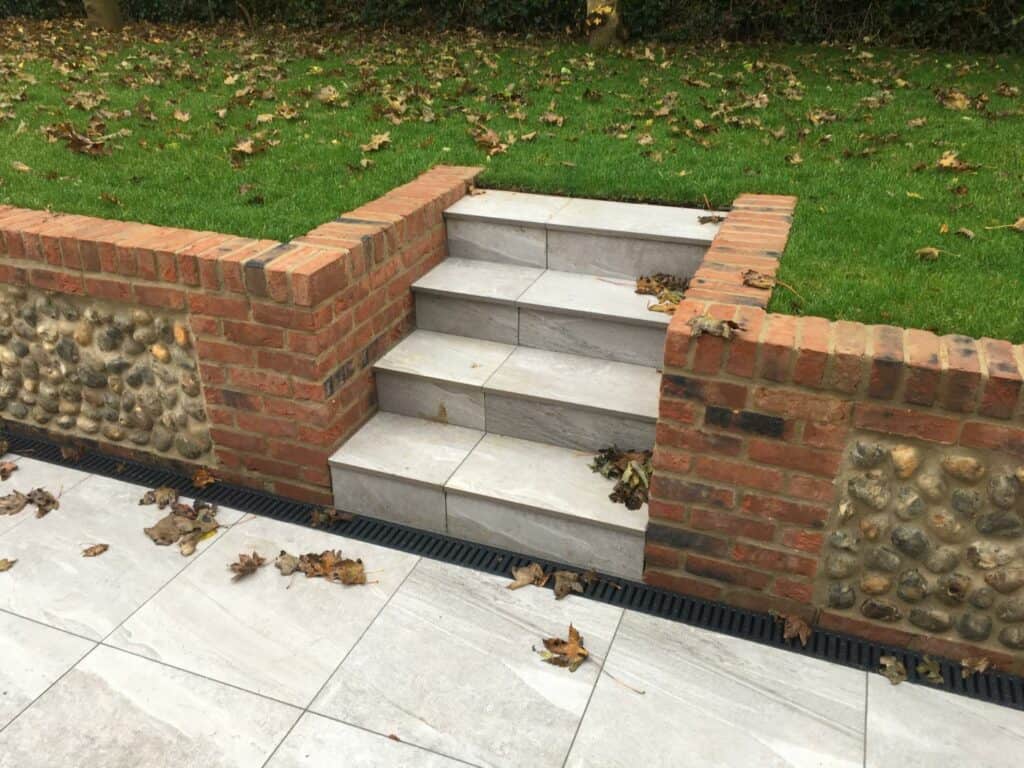 Marble steps with brick sidewalls in garden.