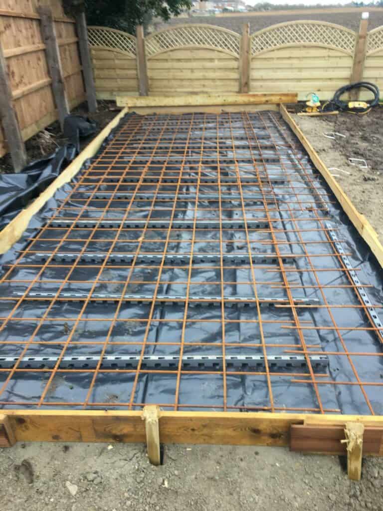 Foundation setup with reinforcing mesh for concrete pouring.