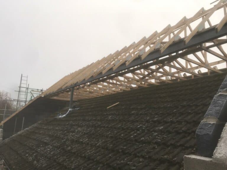 Construction of wooden roof framework over existing building.