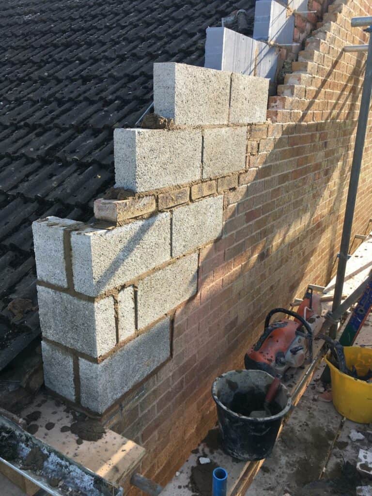 Partial brick wall construction site.