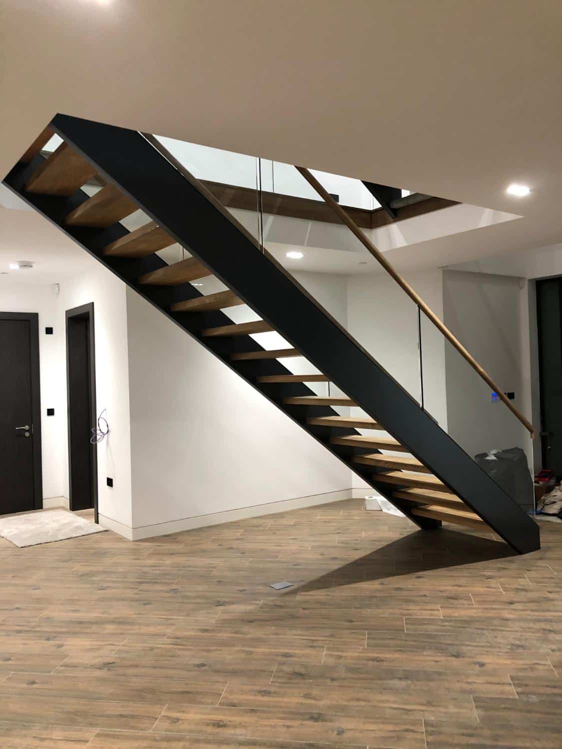 Modern floating staircase with glass balustrade.