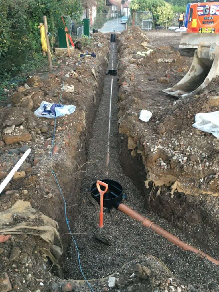 Trench for utility pipes installation at construction site.