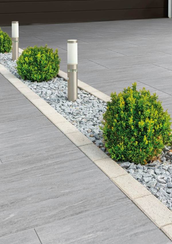 Modern garden pathway with lights and shrubs.