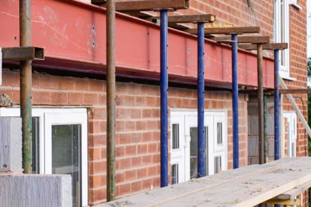 Scaffolding on a brick house under construction.