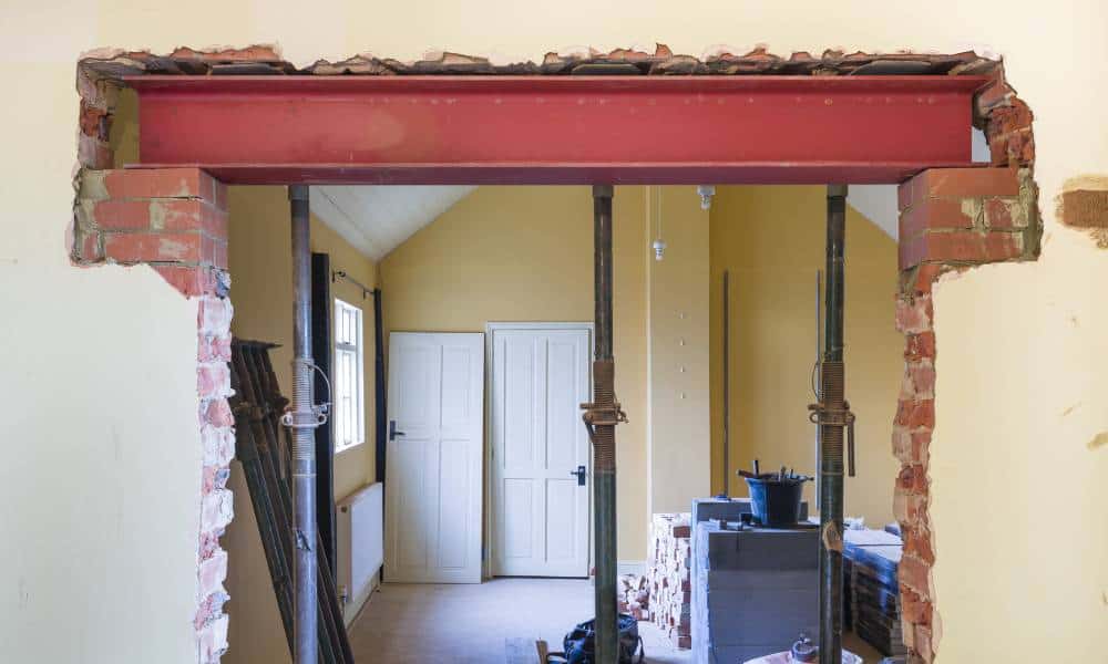 Home renovation with exposed support beams and brickwork