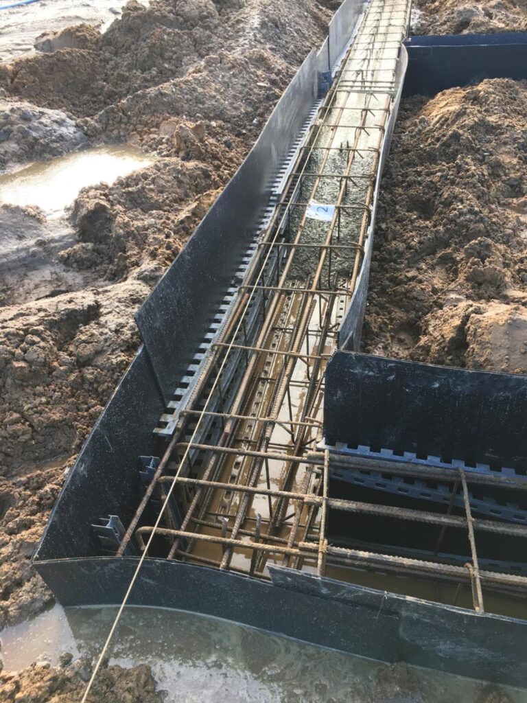 Reinforced steel cages set inside foundation formwork during structural work in King’s Lynn.