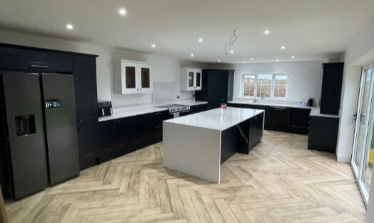 Kitchen extension by Optimal Developments builders in King's Lynn, navy shaker units and herringbone flooring