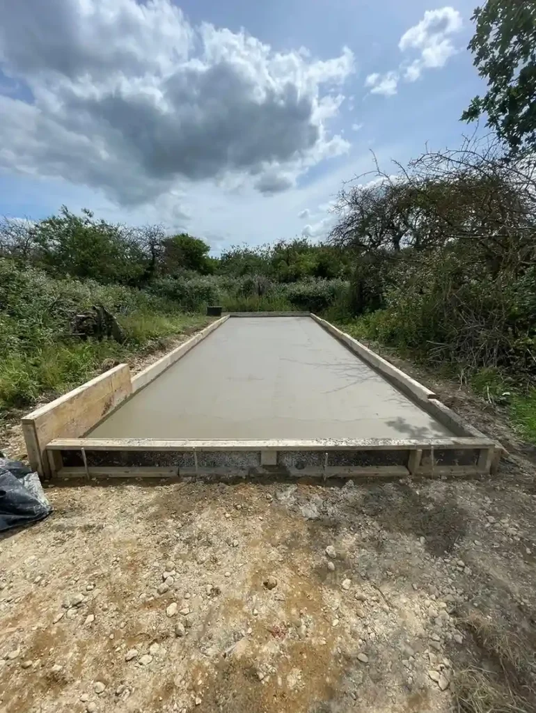 Concrete Services in King's Lynn showing a freshly poured and levelled concrete driveway within timber formwork.
