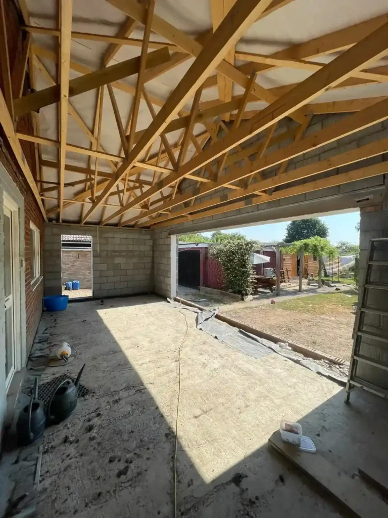 Home Extensions in King’s Lynn with timber roof trusses and blockwork under construction.