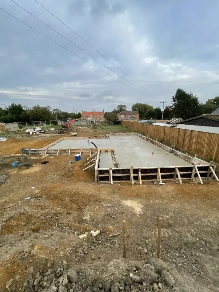 Concrete Services in King's Lynn showing a large poured and levelled foundation slab within timber formwork.